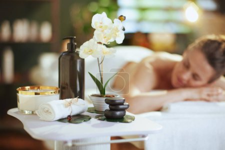 Photo for Healthcare time. Closeup on spa composition. in background relaxed female in spa salon laying on massage table. - Royalty Free Image