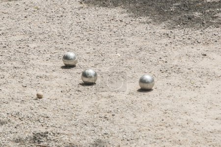 Photo for Petanque balls (boules) close to  jack target ball on gravel petanque ground - Royalty Free Image