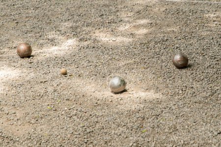 Photo for Petanque balls (boules) close to  jack target ball on gravel petanque ground - Royalty Free Image