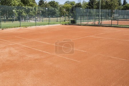 Photo for Red clay court surface closeup in tennis complex - Royalty Free Image