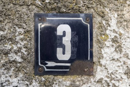 Weathered grunge square metal enameled plate of number of street address with number 3