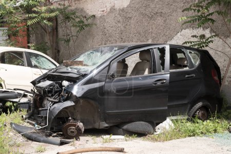 Crashed broken down car in automobile junk scrap yard