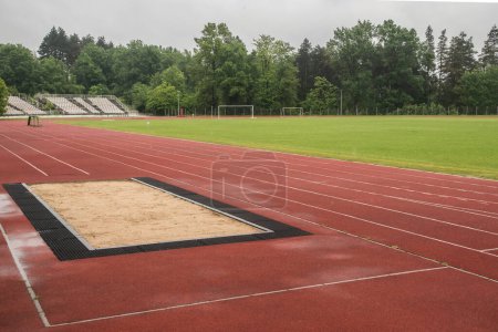 Photo for Long jump sand pit and track and field lines in stadium - Royalty Free Image