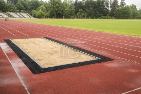 Photo for Long jump sand pit and track and field lines in stadium - Royalty Free Image