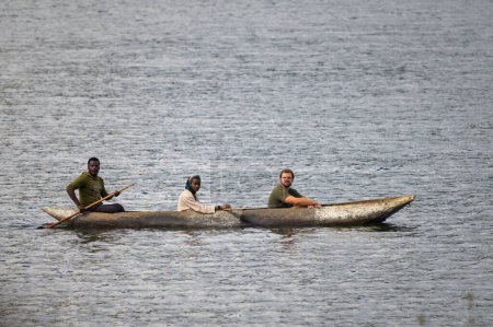 Photo for Kabale, Uganda - June 12, 2022: Tourist in a dugout canoe on Lake Bunyonyi (Uganda), sunny day in summer - Royalty Free Image