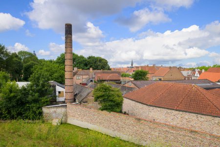 Foto de Bruges, Belgium-July 3, 2022: An old chimney in the city of Bruges, daylight, nature - Imagen libre de derechos