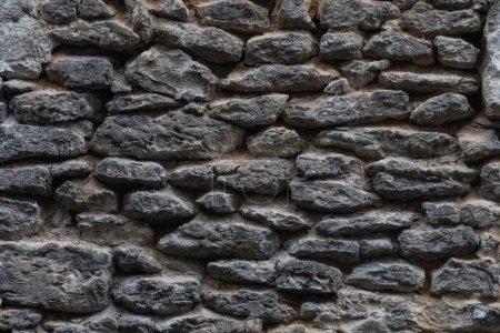 Foto de Fragmento de un antiguo muro de piedra. Foto de primer plano - Imagen libre de derechos