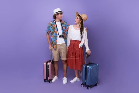 Photo for Happy couple tourist hugging together with baggage going to travel on holidays isolated on studio background. - Royalty Free Image