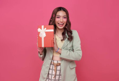 Photo for Happy beautiful Asian teen woman smile with red gift box isolated on pink background. Teenage girls in love, Receiving gifts from lovers. Christmas and Valentines Day concept. - Royalty Free Image