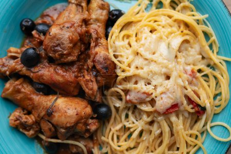Photo for Chicken cacciatore with black olives, pepperoni, tomatoes, with italian spaghetti pasta. Italian food - Royalty Free Image