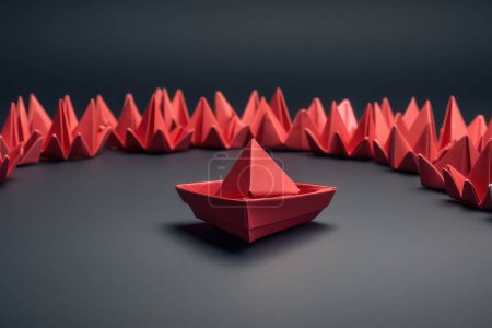 Photo for One outstanding bigger paper boat among many other smaller ones on dark grey background. Conceptual success still life images. - Royalty Free Image