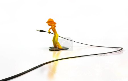 Photo for Firefighter action figure holding an audio cable - Royalty Free Image