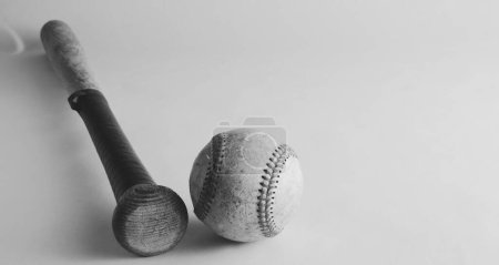 Foto de Wooden baseball bat with ball, isolated on background with copy space for sport. - Imagen libre de derechos