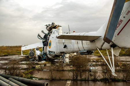 Photo for Destroyed combat helicopteres at the International Airport of Kherson, located in Kherson Oblast in Ukraine. The Chernobaivka attacks are a series of Ukrainian attacks on the Russian-held Kherson International Airport during the Russian invasion camp - Royalty Free Image