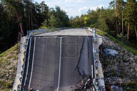 Photo for On the Lyman road, the bridge was deliberately blown up by the Ukrainian army to prevent the Russian invaders from advancing towards the Lyman road. This tactic of warfare is frequently used to slow down the advance of enemy forces. - Royalty Free Image