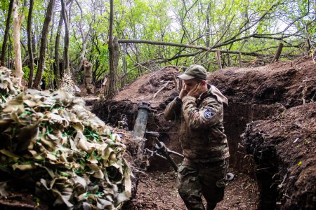 Ukrainian soldier from the 28th Artillery Battalion firing a 120mm mortar at a Russian target in the zero line in the forest near Bakhmut. The Russian and Ukrainian armies clash in the Donbass, the fighting is intense and the battle is raging. With a