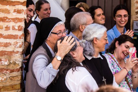 Photo for Nuns participating at the Corpus Christi procession, an age-old tradition of the Catholic faith to process the real presence of Jesus. Eucharistic processions take place in the narrow streets of the old town of Carmona which is reputed to be one of t - Royalty Free Image