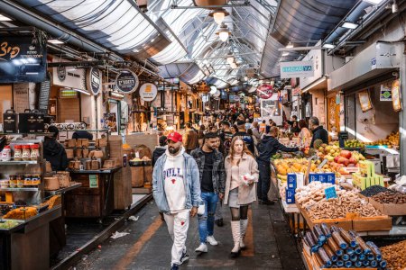Photo for Jerusalem, Israel - December 22, 2023 People shopping at Mahane Yehuda Market, often referred to as "The Shuk", is a marketplace in Jerusalem. Popular with locals and tourists alike - Royalty Free Image