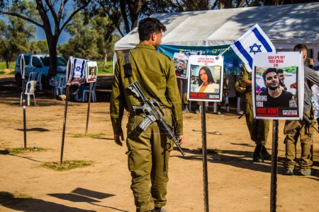 Photo for Re'im, Israel  January 5, 2024 Israeli soldiers come to pay tribute to those who were killed during the terrorist attack against the NOVA festival which took place on October 7, 2023 a few kilometers from Gaza in the south of Israel - Royalty Free Image