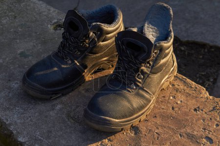 Photo for Mens boots on a concrete background in sunlight. High quality photo - Royalty Free Image