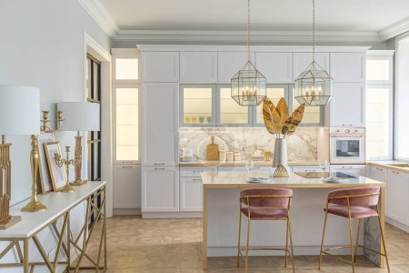 una vista cercana de la elegante cocina blanca con una isla de cocina en el lujoso interior de un apartamento moderno en colores claros con muebles elegantes.