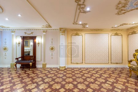 Photo for Luxurious living room interior with beautiful old carved furniture of gold color with decorations on the walls in the style of the royal palace - Royalty Free Image