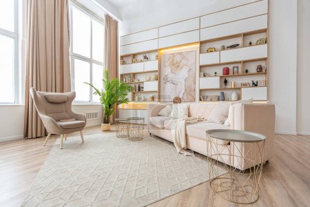 Photo for Interior design spacious bright studio apartment in Scandinavian style and warm pastel white and beige colors. trendy furniture in the living area and modern details in the kitchen area. - Royalty Free Image