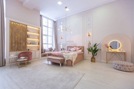 Photo for Luxurious modern bedroom interior of an expensive spacious light stylish apartment. upholstered furniture and decorative lighting, soft pastel colors and cozy atmosphere - Royalty Free Image