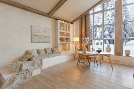 gemütlich warme Home Interieur eines schicken Landchalet mit einem riesigen Panoramafenster mit Blick auf den Winterwald. offener Grundriss, Holzdekoration, warme Farben und ein Familienherd