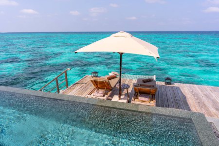 Luxurious exterior of a very expensive rich water villa in the Maldives, decorated with natural wood.