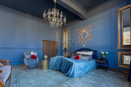 Photo for Luxury posh bed room interior in deep blue color with antique expensive furniture and gold elements in baroque style - Royalty Free Image