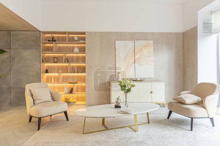 modern interior design of the living area in the studio apartment in warm soft colors. decorative built-in lighting and soft beige furniture