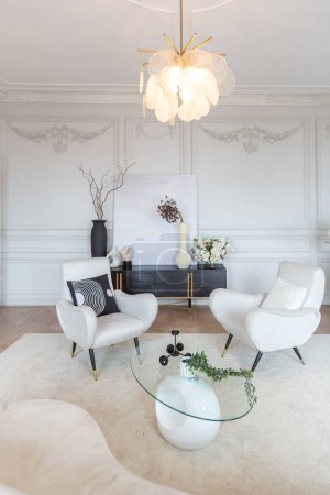 Photo for Rich luxurious interior of a cozy room with modern stylish furniture nd grand piano, decorated with baroque columns and stucco on the walls - Royalty Free Image
