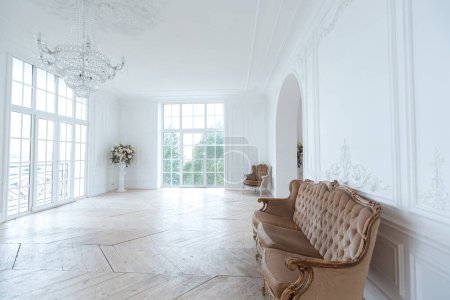 Photo for Chic white huge spacious hall with a minimum of expensive antique furniture. Baroque interior design with ornament on the walls and parquet on the floor. - Royalty Free Image