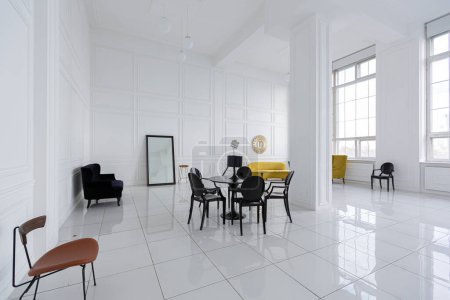 Photo for Modern fashionable futuristic interior design of a spacious white hall with black and yellow furniture - Royalty Free Image