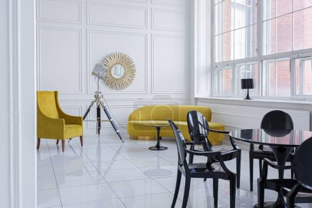 Photo for Modern fashionable futuristic interior design of a spacious white hall with black and yellow furniture - Royalty Free Image