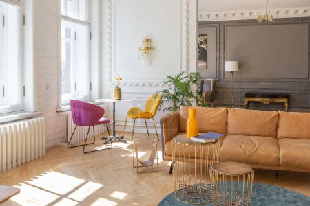 Photo for Luxury interior of a spacious apartment in an old 19th century historical house with modern furniture. high ceiling and walls are decorated with stucco - Royalty Free Image