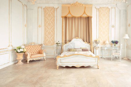 Photo for Very rich interior of the apartment with golden decorations on the walls in the Baroque style and luxury furniture with gold paint. - Royalty Free Image