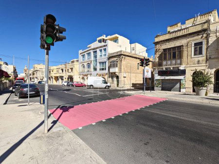 Photo for City pedestrian crossings are painted pink to draw attention to month of breast cancer awareness in October: Paola, Malta - October 2, 2022 - Royalty Free Image
