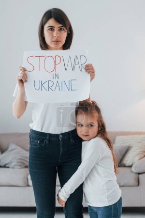 Photo for Mother with her little daughter standing with banners with text stop war in Ukrane. - Royalty Free Image
