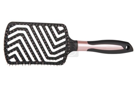 Massage comb for combing hair. Plastic brush with metal corners for detangling hair. On an isolated white background.