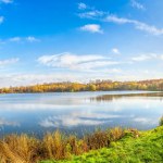 Panoramic view of autumn park on pond in Katowice, Poland