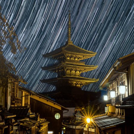 Photo for A long exposure evening street view of the Yasaka padoda illuminated by the ground and star trails in the sky - Royalty Free Image