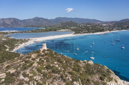 Photo for Aerial view of Spiaggia di Porto Giunco, a beautiful bay near a 17th century watchtower, The Aragonese Tower of Porto Giunco, in Sardinia, Italy - Royalty Free Image