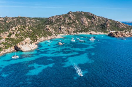 Photo for Aerial view of Spargi Island with Cala Corsara, a white sand beach bathed by a turquoise water and a tourist speedboat in the La Maddalena Archipelago, Sardinia, Italy. - Royalty Free Image