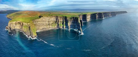 Photo for Aerial panoramic view of the Cliffs of Moher near sunset along the Burren region in County Clare, Ireland - Royalty Free Image