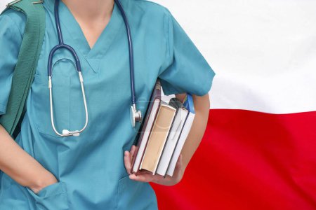 Photo for Close-up young female student doctor with stethoscope and books in hand on Poland flag background. Nurse, Student, Education. Medical woman student at the university. Medical education in Poland - Royalty Free Image