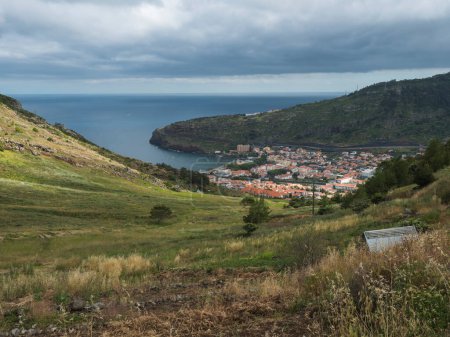 Aerial view on Machico town from Levada do Canical hiking trail. Footpath in green hills and tropical vegetation on Madeira island, Portugal, Europe