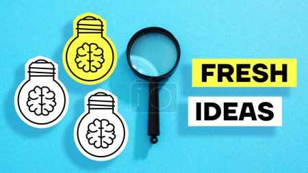 Photo for Fresh ideas are shown using a text and pictures of light bulbs - Royalty Free Image