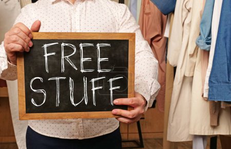 Free stuff, message on a board hold by businessman.